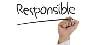 Photo of hand writing the word "responsible"