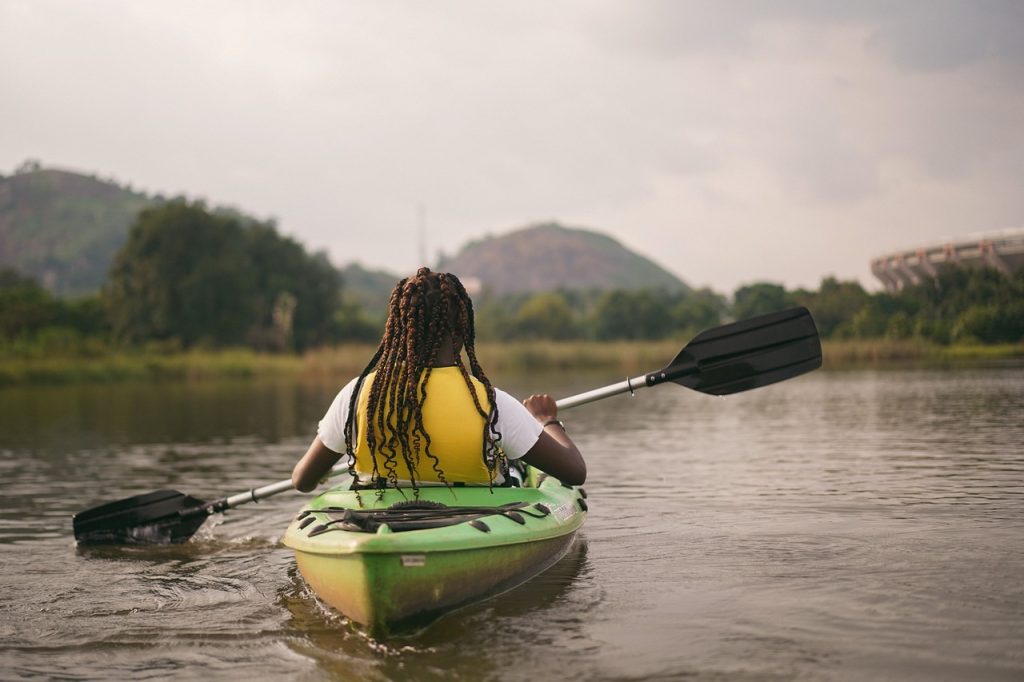 A person in a kayak on a wide river or bay