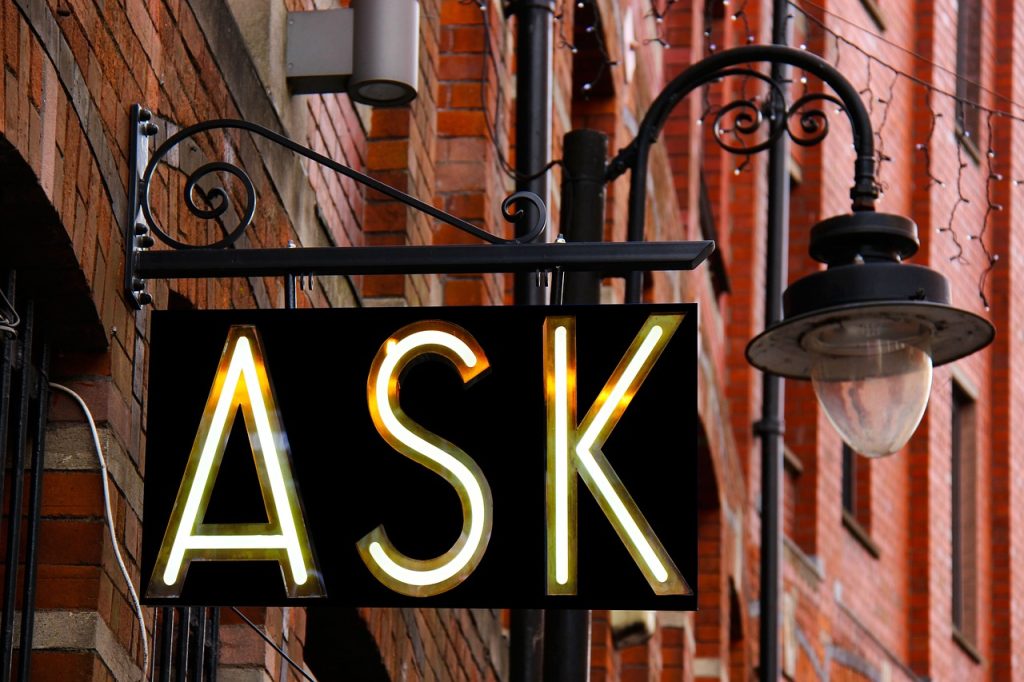 Exterior sign with lamp, sign reads "ASK"
