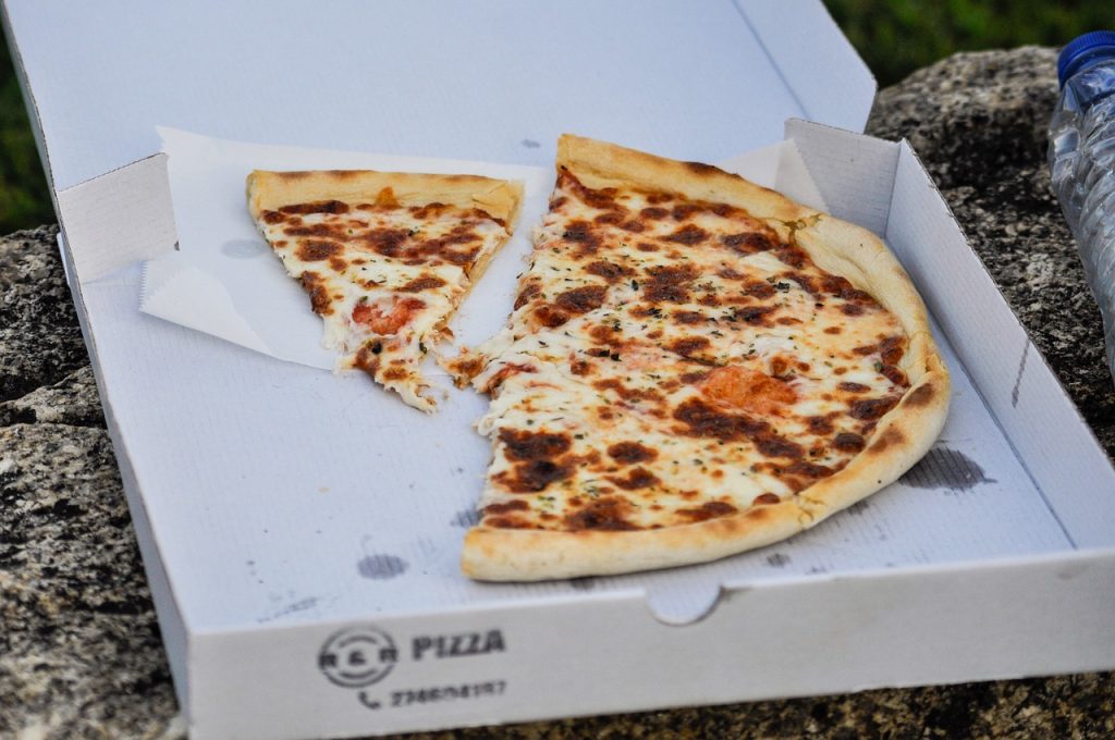 Leftover pizza inside pizza box