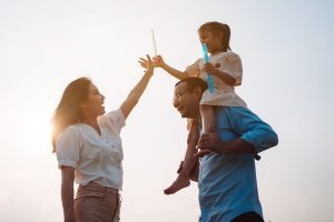 Mother, Father and child playing outside.