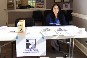 A person sits at a registration table.