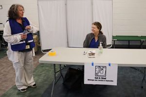 Two people chat at a table.