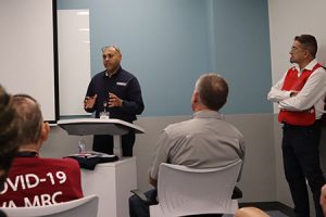 A person speaks from a podium.